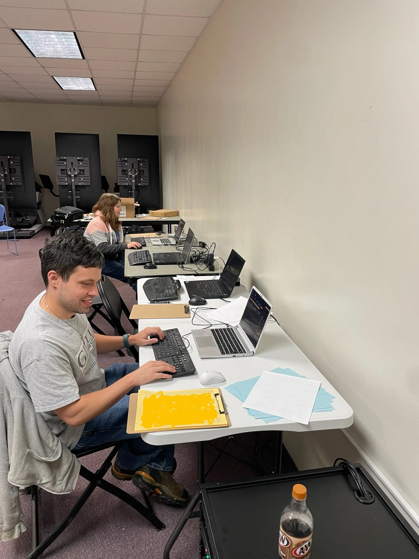 Two volunteers entering data near the end of the 2024 Theme Basket Auction